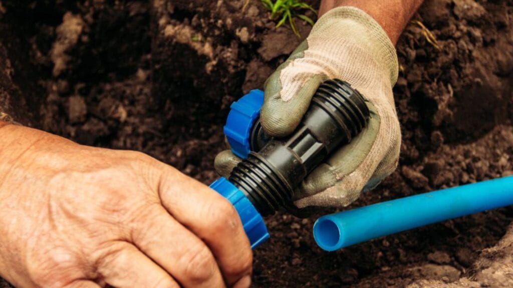 Irrigation piping installed in garden soil for landscape watering.