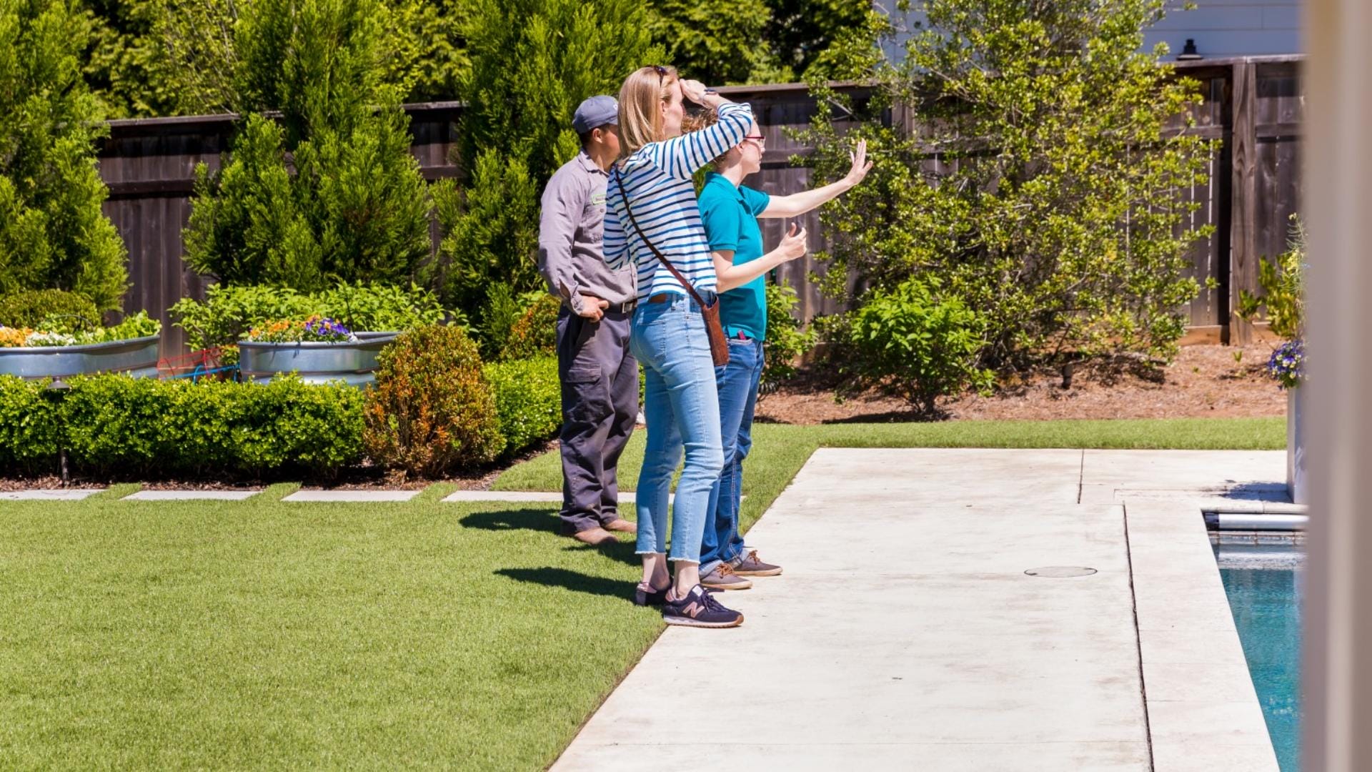 landscape designer reviewing residential yard plans on-site in Kamloops BC