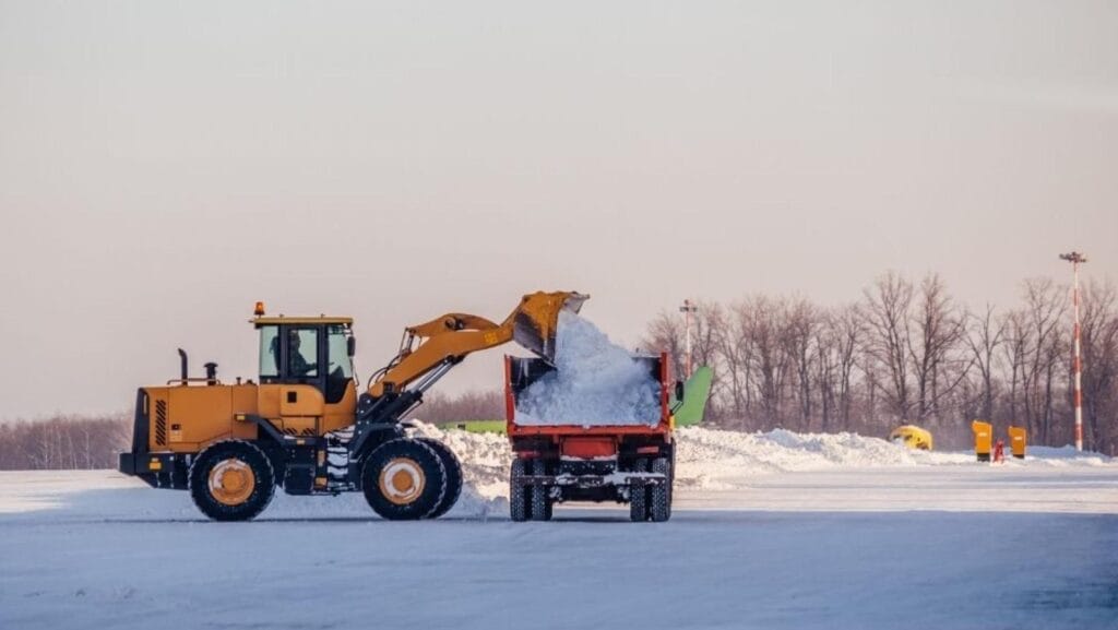 Snow removal equipment clearing a driveway in the BC Interior winter by Lyons Landscaping