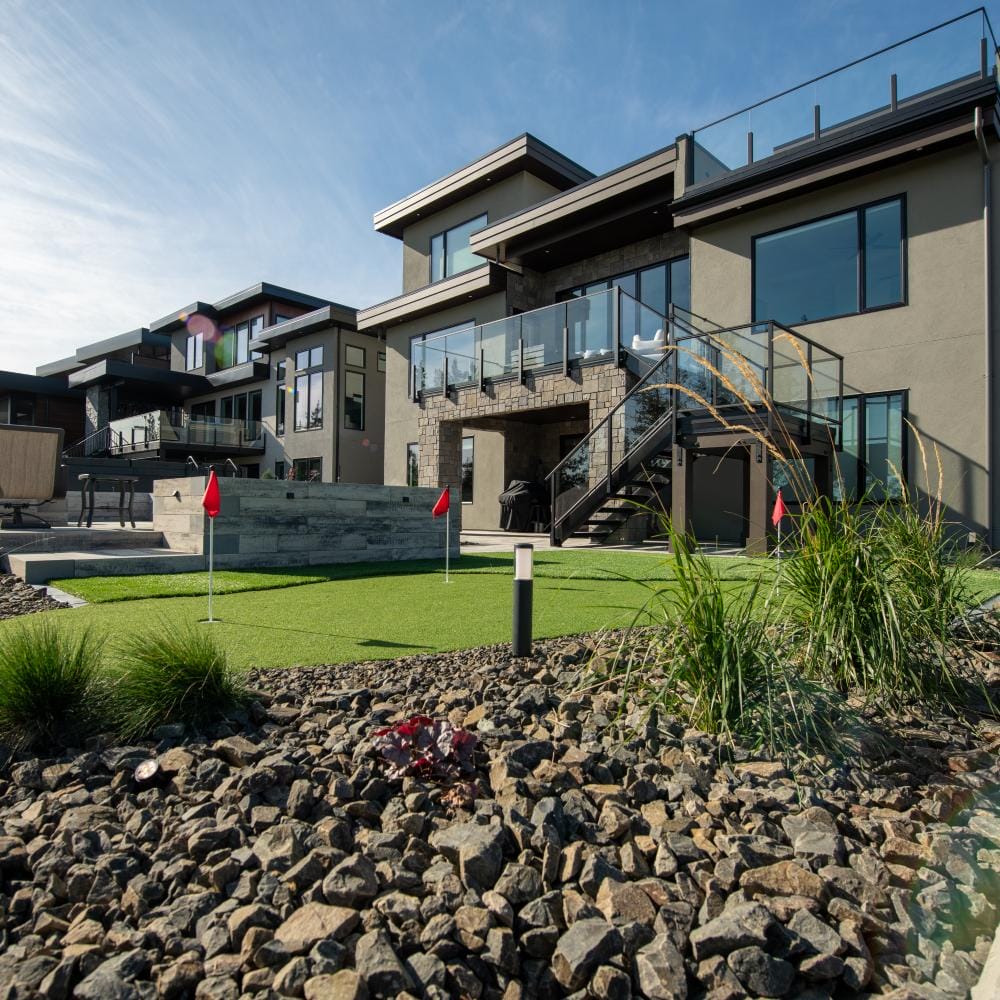 FireSmart landscaping with rock mulch and spaced plants around a Kamloops home