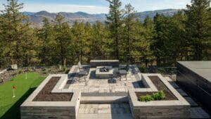 hardscaping services Kamloops BC — stone patio with retaining wall and native plantings in BC Interior landscape