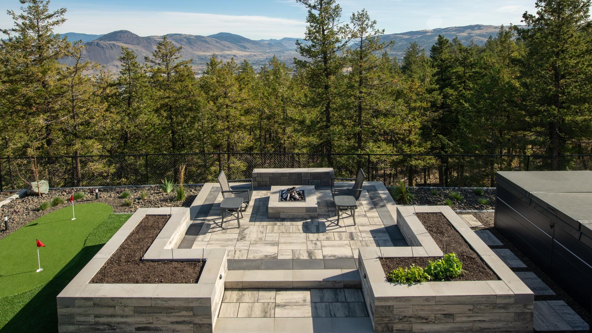 FireSmart hardscape design with crushed granite ground cover and stone patio on BC Interior residential property
