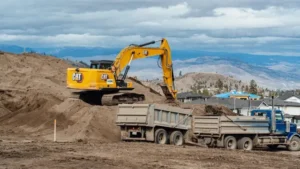 A Lyons excavator and dump truck working on a civil excavation project in Kamloops.