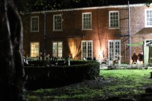 beautifully lit residential backyard with pathway lighting and uplighting on trees in Kamloops BC
