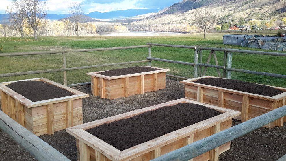 newly installed raised garden beds in a Kamloops BC backyard with sandy native soil visible beside them