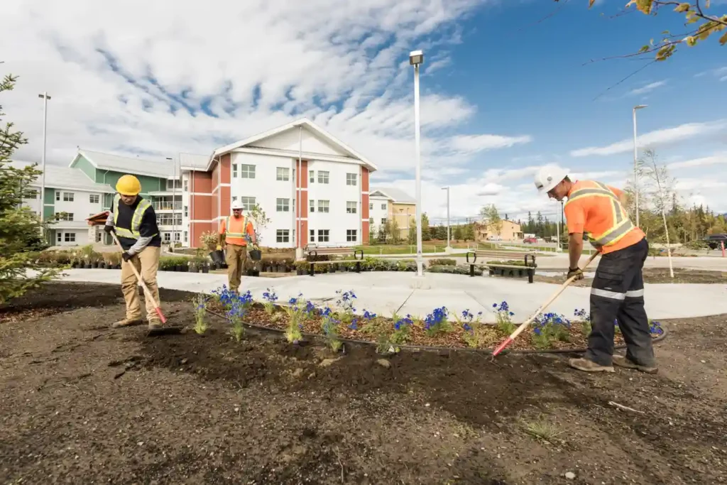 landscaping crew performing seasonal grounds maintenance at a commercial property in Kamloops BC