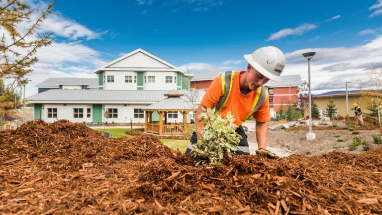 Commercial landscaper performing softscaping work outside a residential property in BC